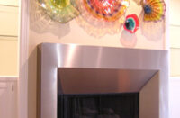 Contemporary fireplace surround built with stainless steel.