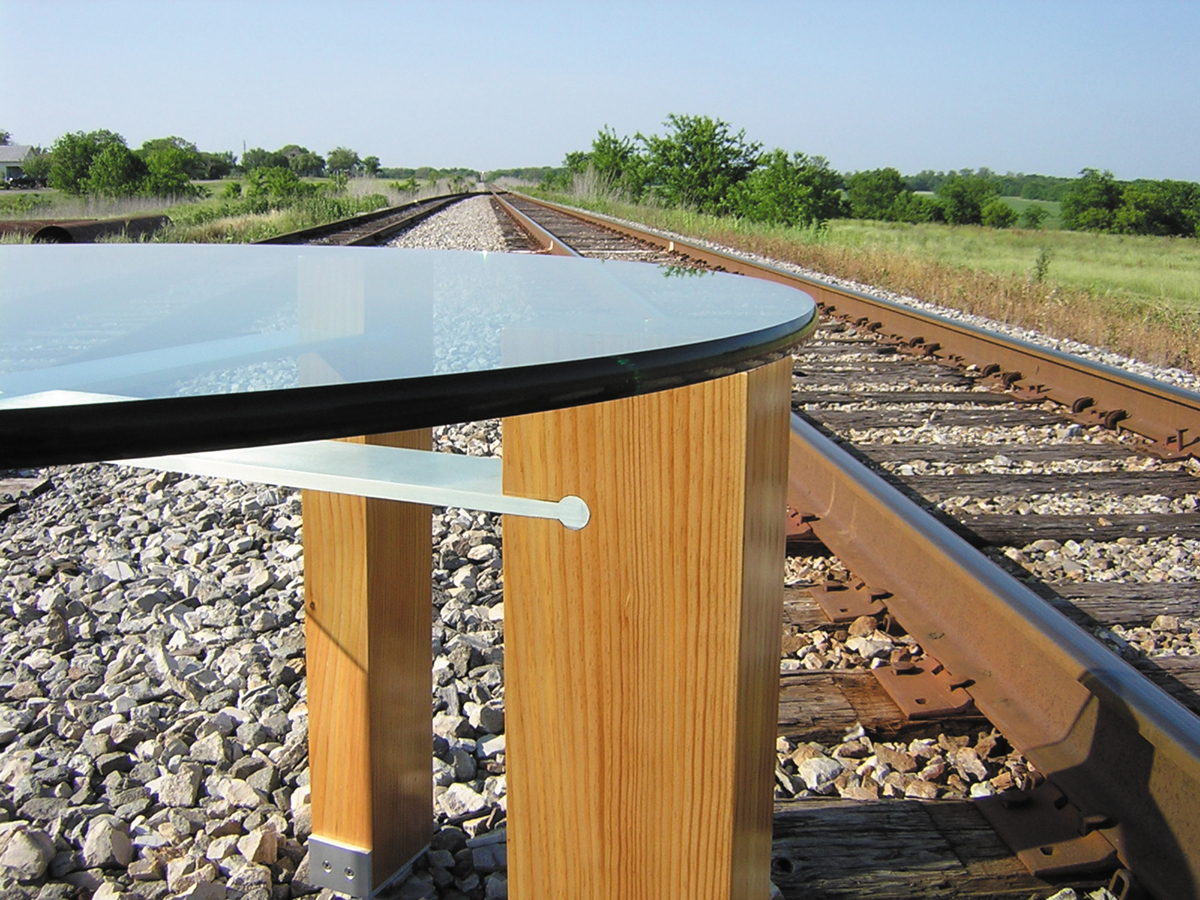 Detail of this table. The aluminum stretchers slot into the pine legs.