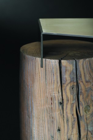 Detail image of a contemporary side table built with southern yellow pine and stainless steel. This sculptural table is part of The Umasi Collection by Ironwood Industries.